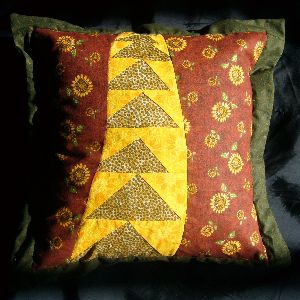 A quilt project, 'Gold Snake in the Grass Cushion,' by Joy-Lily.