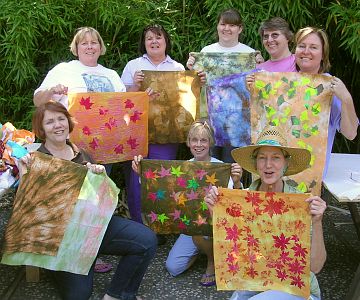 Group of women with leaf-design fabrics