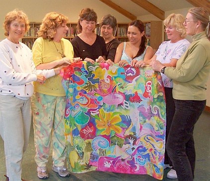 Silk painters hold up shared piece