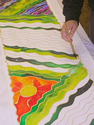 Close-up of triangular red sun painted on silk scarf